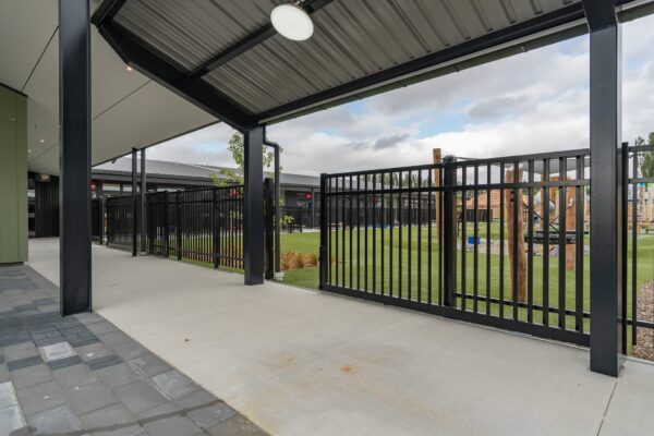 black sliding metal gate and fence designed and installed by Axiom Built at Pītau-Allenvale School in Belfast, Christchurch