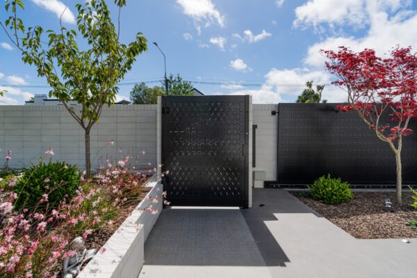 custom black aluminium architectural gate installed by Axiom Built at residential home in Christchurch
