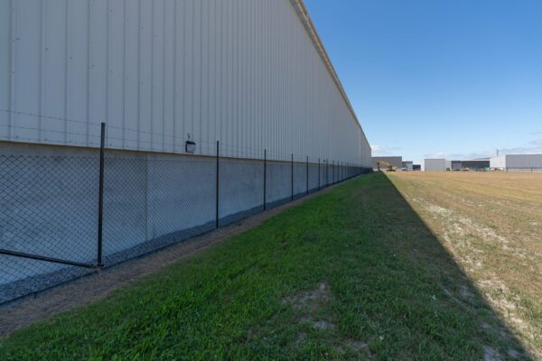 Black chainlink security fencing installed around the perimeter of a commercial building, by Axiom Fencing, Balustrades & Gates in Christchurch NZ